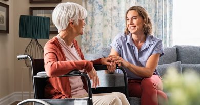 Happy adult woman visiting her elderly mother at home